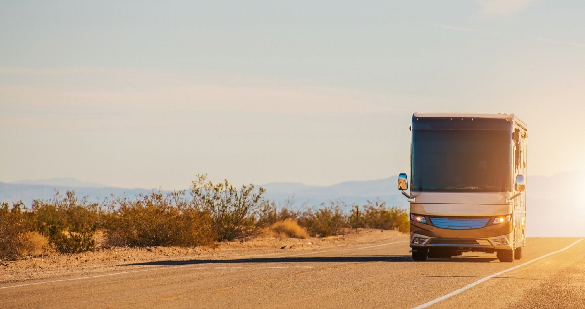 Motorhome travelling a Central Oregon highway at sunset